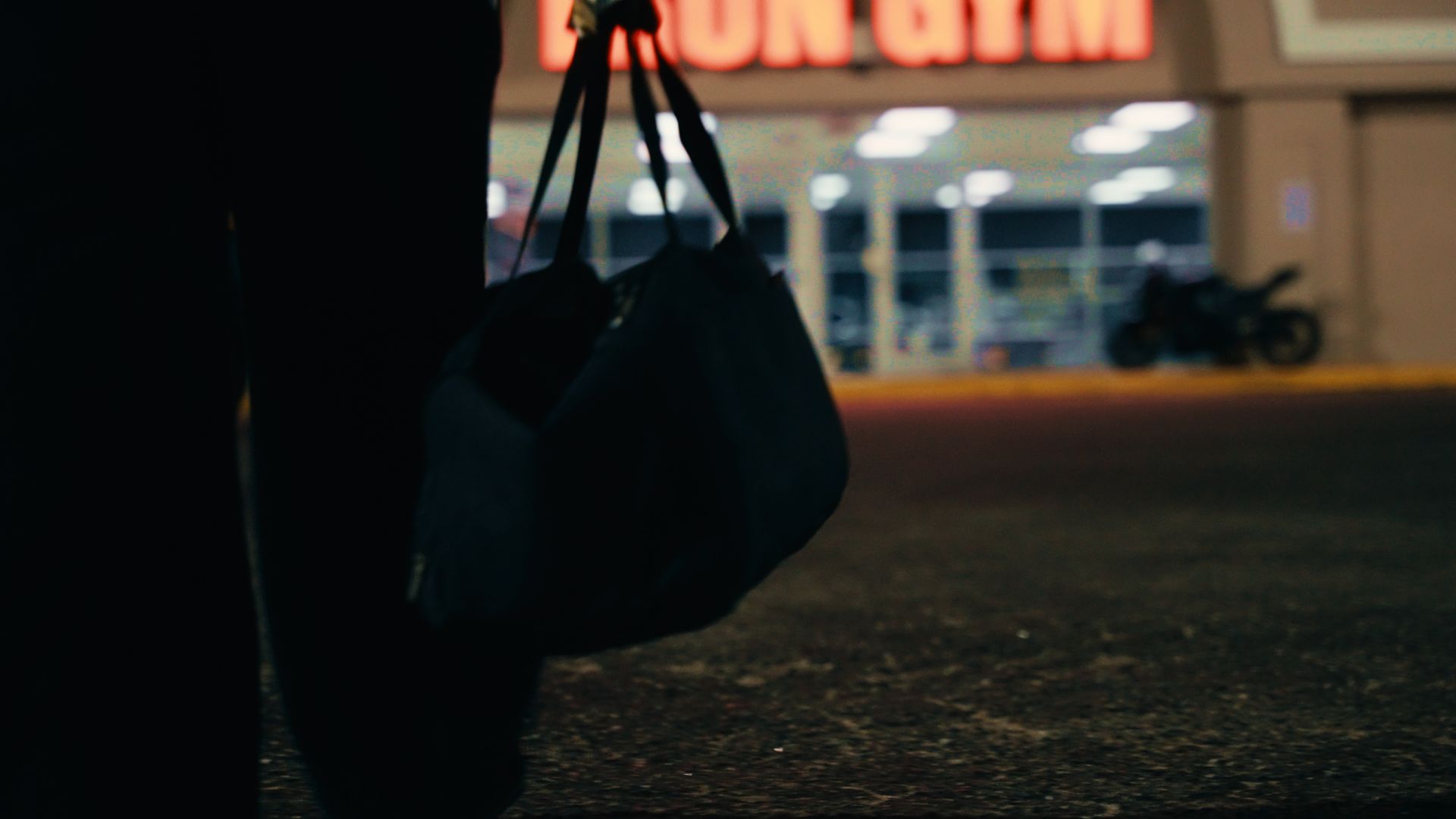 Walking into the gym at night with a bag